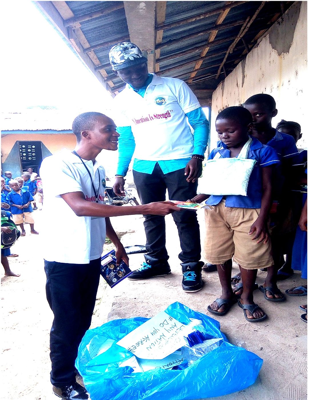 A CARDO volunteer handing a certificate to a child