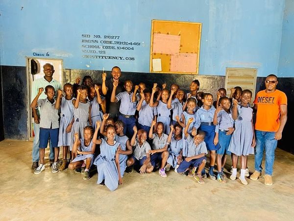 Pupils and CARDO staff in a classroom group photo