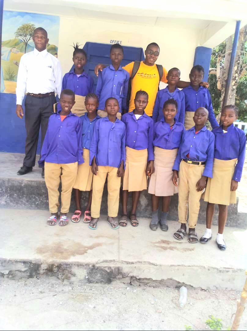 Girls in school uniform with an adult, 2022