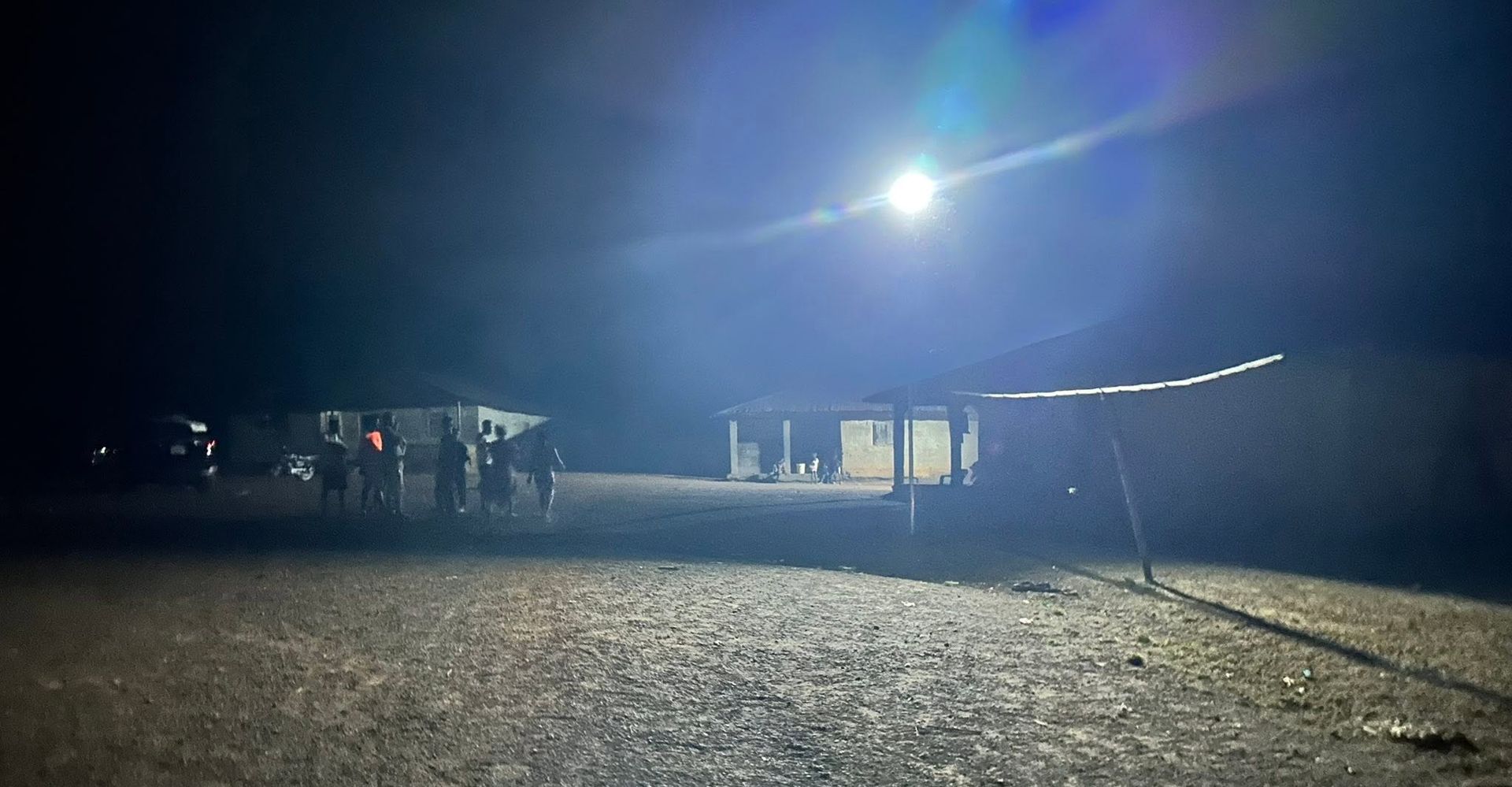 A village square lit at night by a CARDO solar street light