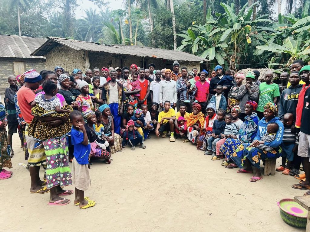 Community members seated together during a meeting in Mabanta village
