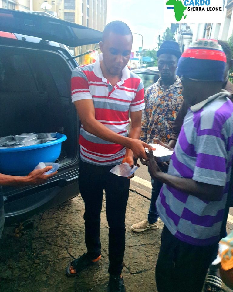 CARDO volunteers handing out food during the Freetown feeding program