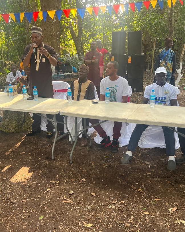 Speakers seated at a table during the project launch in Kasimberia village